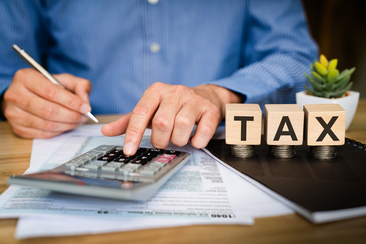 An investor calculating capital gains taxes.